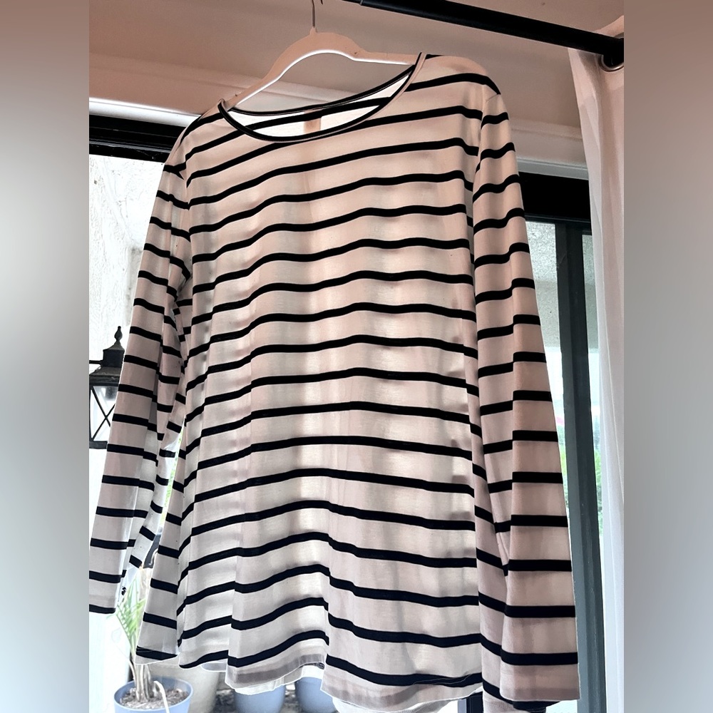 Long sleeved, black and white striped shirt, elbow patches.